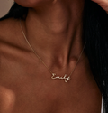 A dainty minimalist name necklace designed with clean lettering and a refined silhouette. Simple and lightweight, it adds a subtle personalized touch to everyday styling.