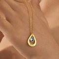 A personalized drop-style name necklace designed with a delicate birthstone-inspired accent. The flowing letter design creates an elegant and meaningful look, suitable for everyday wear or thoughtful gifting.