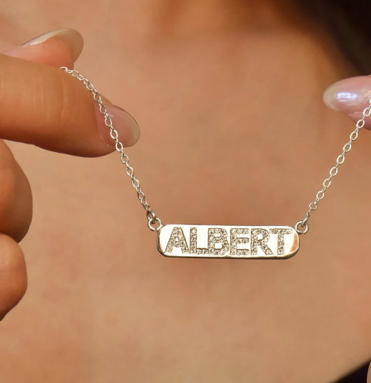 A delicate personalized bar necklace designed with custom lettering and subtle crystal accents. Minimalist, lightweight, and suitable for everyday wear or thoughtful gifting.