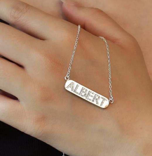 A delicate personalized bar necklace designed with custom lettering and subtle crystal accents. Minimalist, lightweight, and suitable for everyday wear or thoughtful gifting.